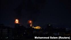 Explosions light up the sky after the Israeli military said in a statement that it has struck Islamic Jihad targets, in Gaza