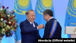 Қазақстан президенті Нұрсұлтан Назарбаев президент әкімшілігі басшысы Әділбек Жақсыбековке "Барыс" орденін тапсырып тұр. Астана, 13 желтоқсан 2016 жыл.