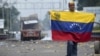 Venezuela - A demonstrator holds a Venezuelan flag on the Francisco de Paula Santander international bridge in Urena, Venezuela, border with Colombia on February 24, 2019, following protests in the region after Venezuelan President Nicolas Maduro ordered 