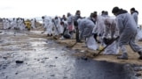 Volunteers remove oil-soaked beach sand near the Black Sea resort town of Anapa 