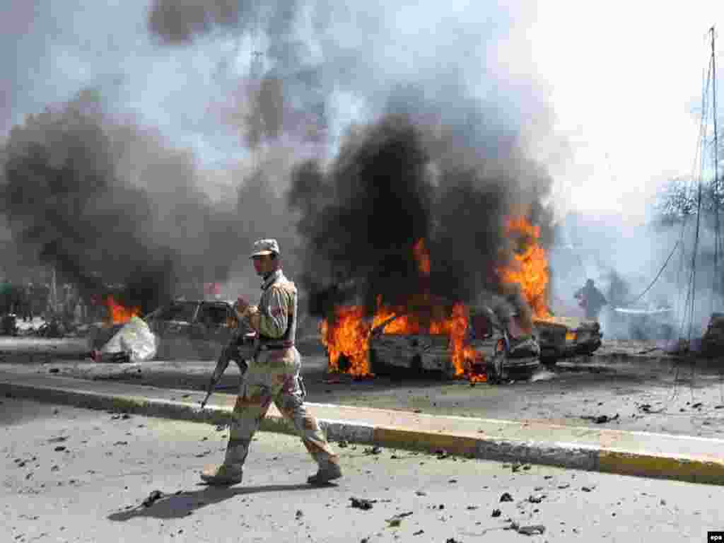 Caption: epa00961896 An Iraqi soldier secures the area at the site of car bomb explosion near the entrance of Green Zone at Karada district in Baghdad on Tuesday 20 March 2007. At least one civilian was killed and five others injured in the blast. EPA